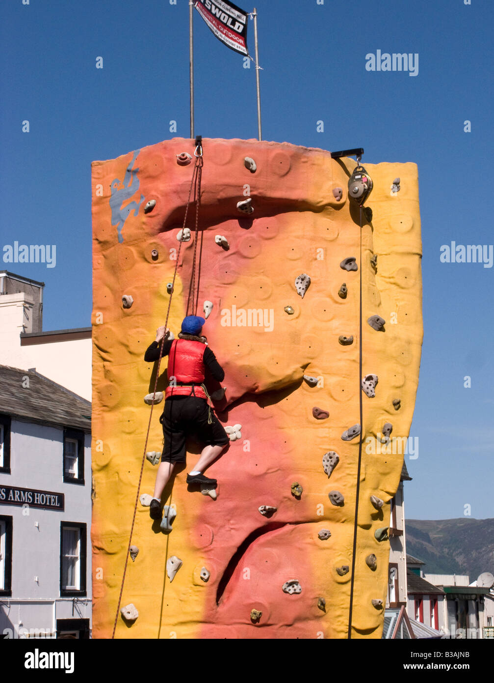 Climber on climbing wall in Keswick town as part of the mountain