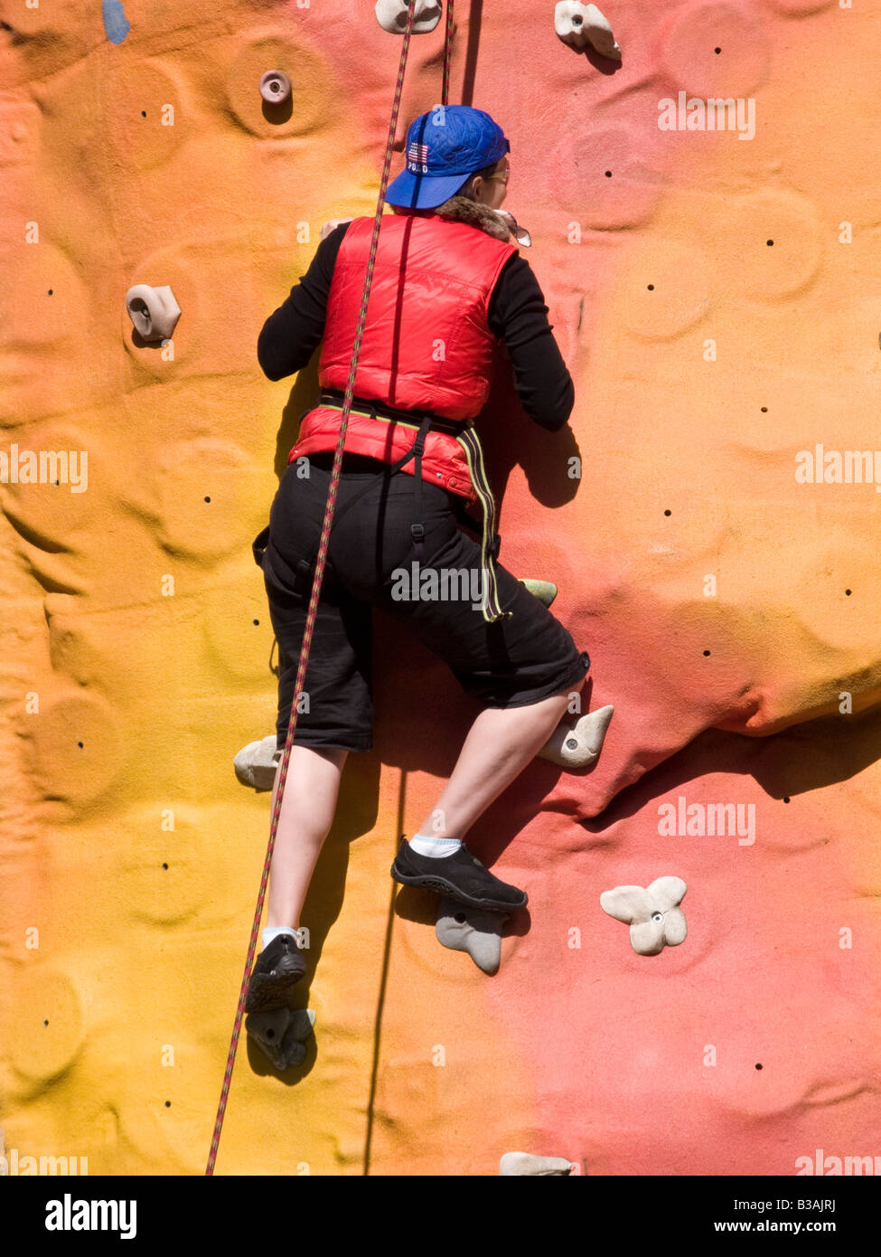 Climber on climbing wall in Keswick town as part of the mountain