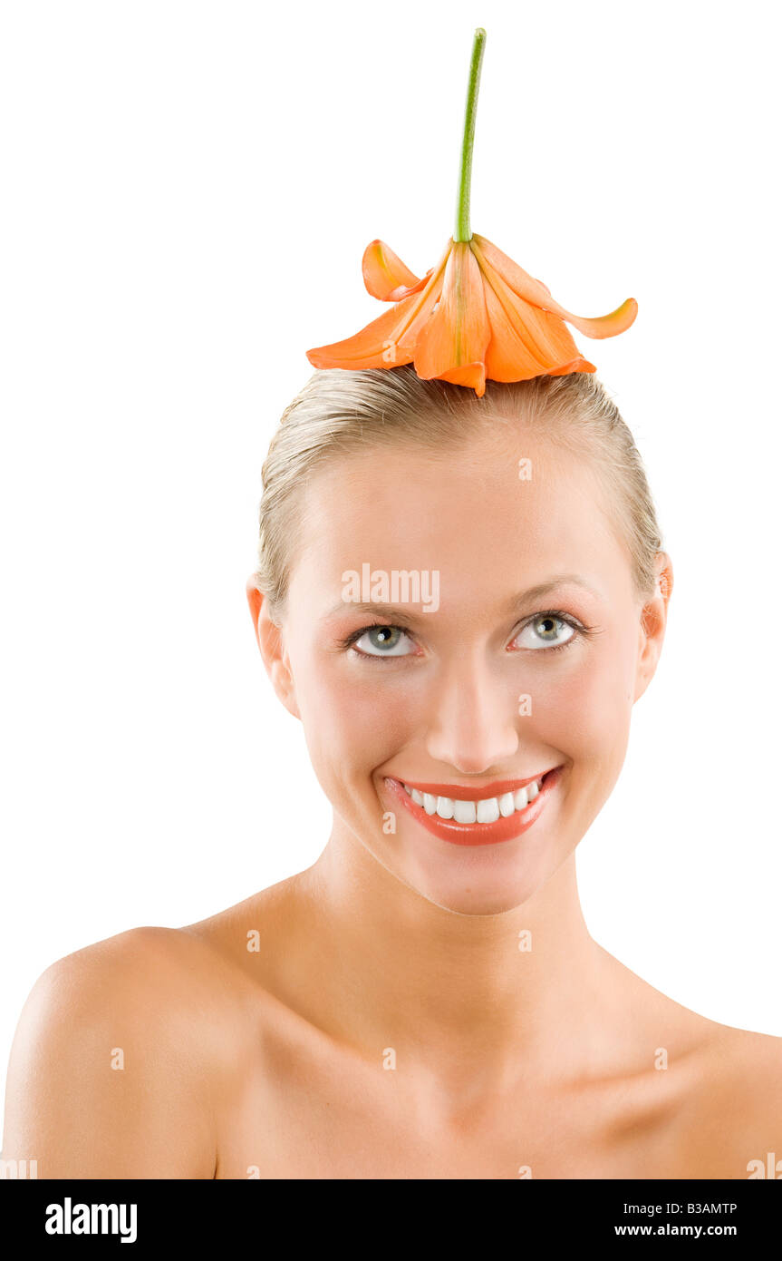 nice girl smiling with an orange flower on her head used like a hat ...