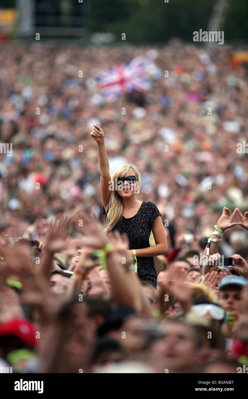 A girl in the crowd enjoying the music at the V Festival in Hylands Park Chelmsford Essex Stock Photo