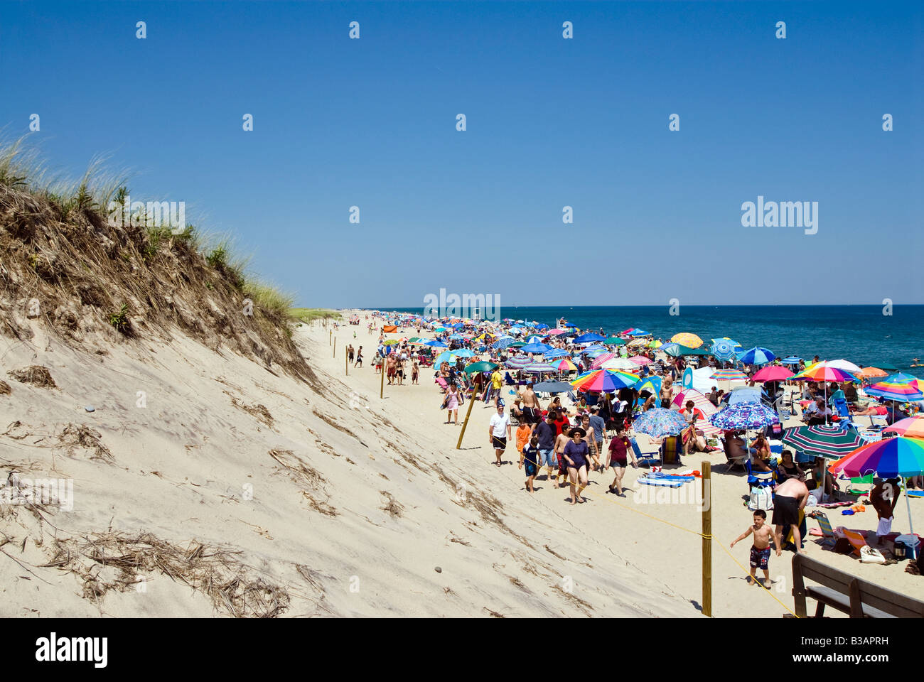 Crowded summer beach with colorful umbrellas, Nauset Beach, Cape Cod National Seashore, Cape Cod, MA Stock Photo