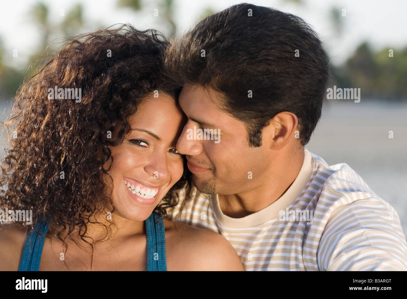 Hispanic couple hugging Stock Photo - Alamy