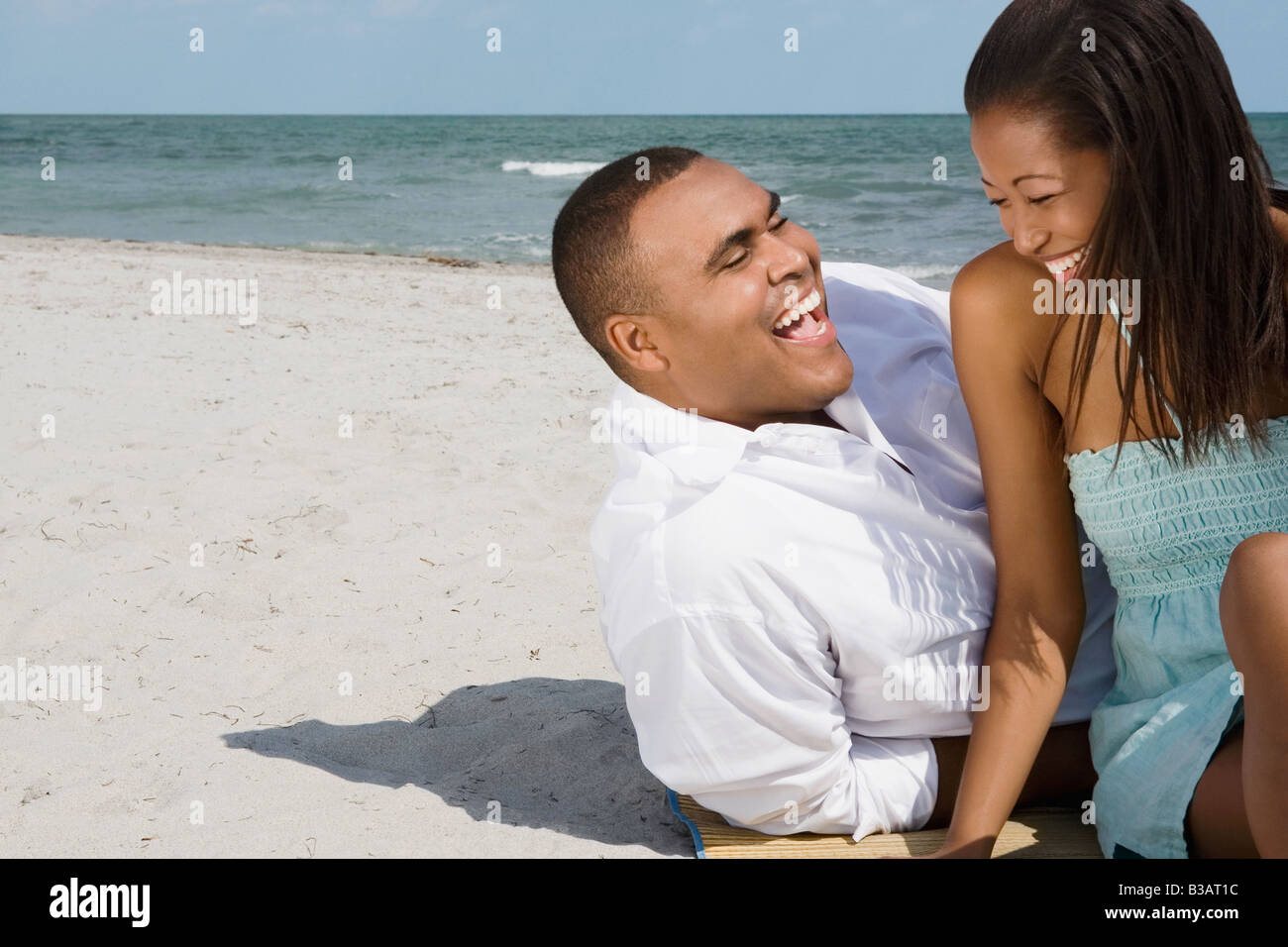 African couple laughing at beach Stock Photo - Alamy