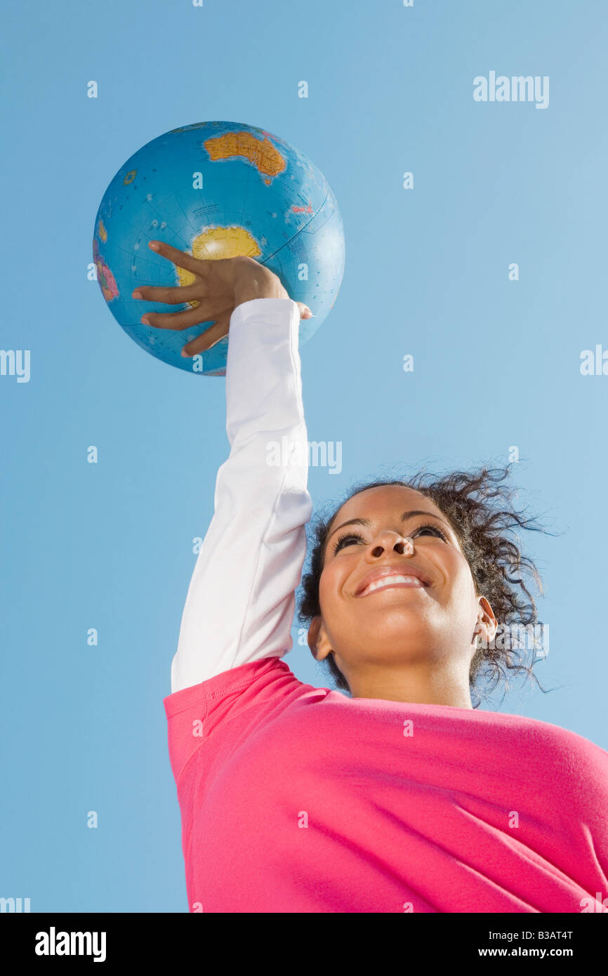 Woman holding up world globe hi-res stock photography and images - Alamy