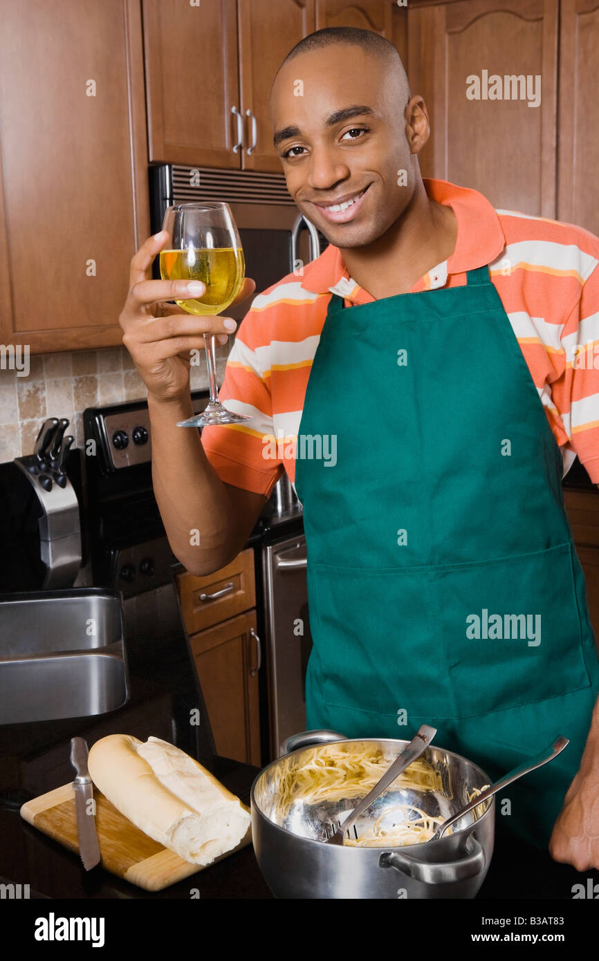 African man cooking and drinking wine Stock Photo Alamy