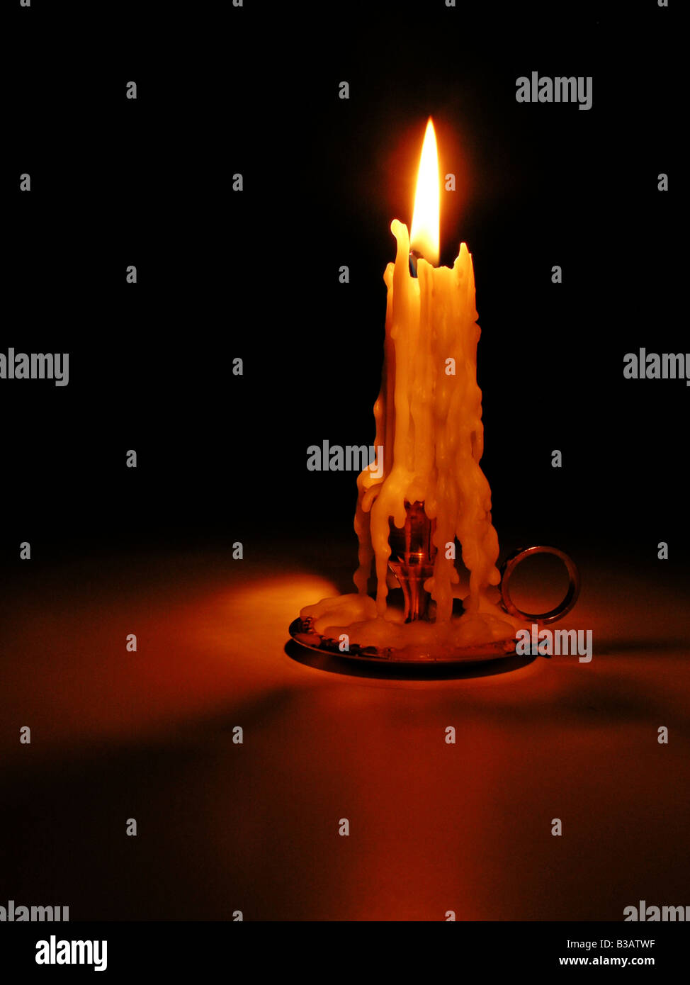 Candle light with wax formation on black background Stock Photo Alamy