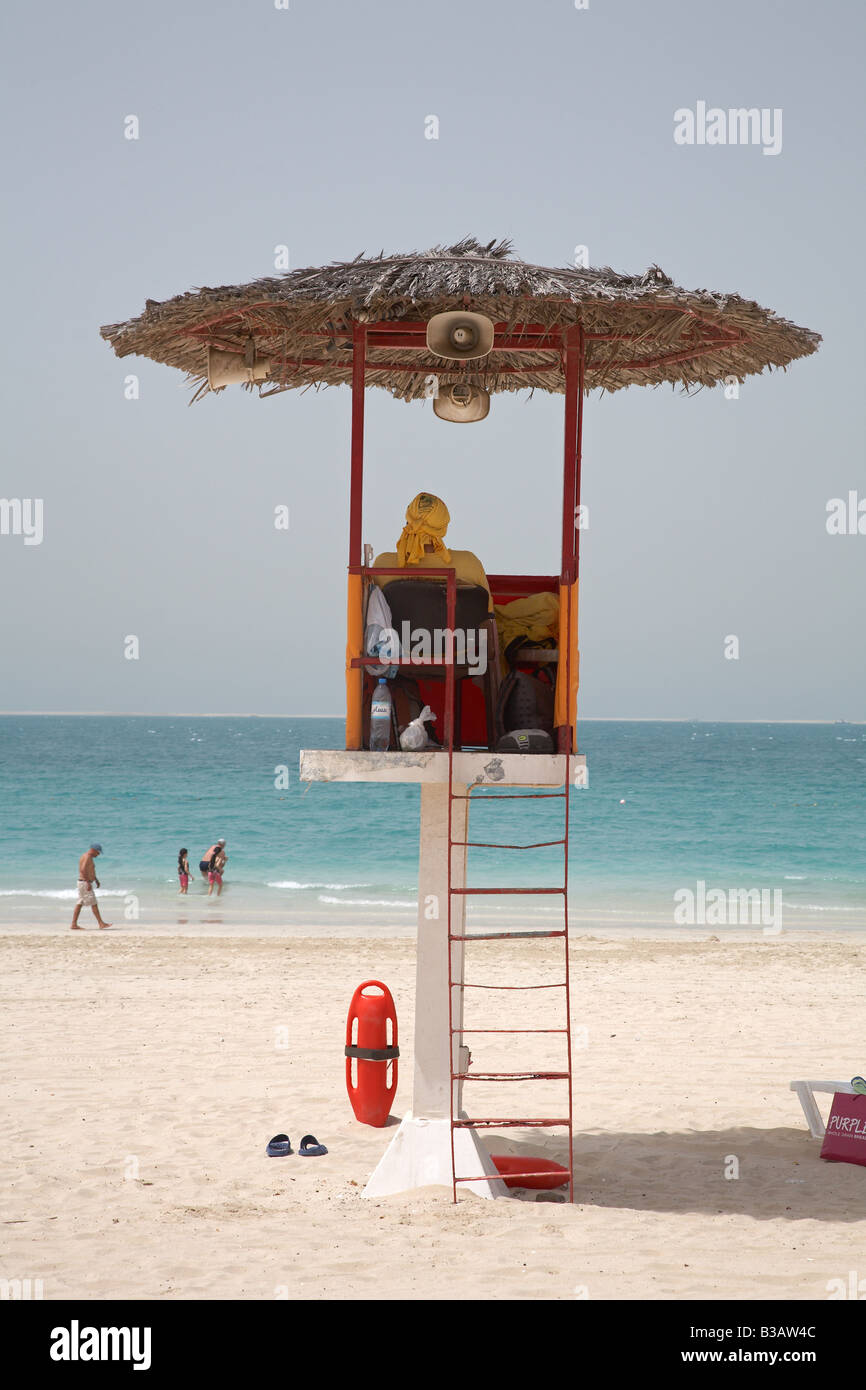 Life guard looking out across the sea from his watch tower at Jumeirah Beach Dubai Stock Photo