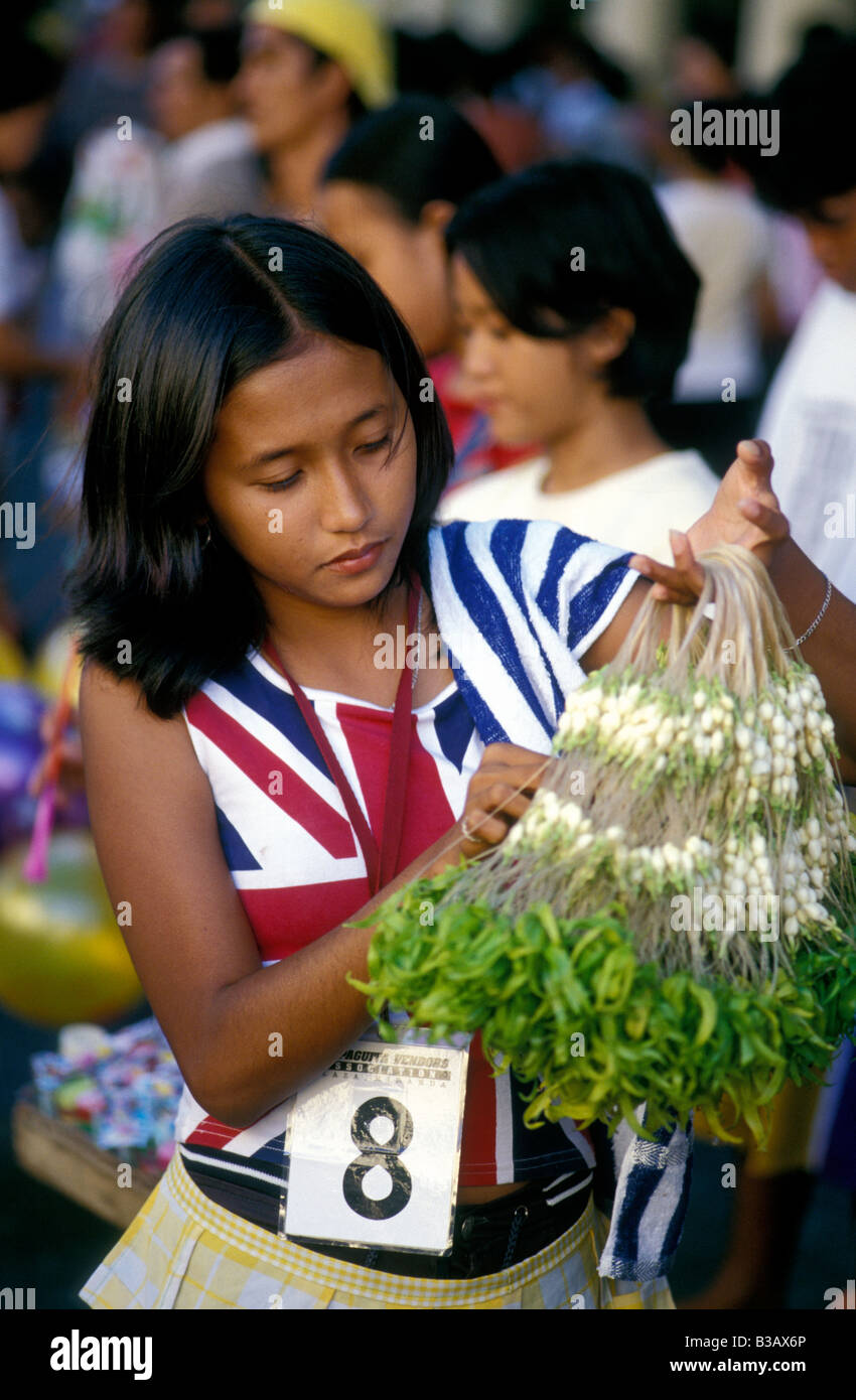 girl selling fragrant flowers outside quiapo church manila philippines
