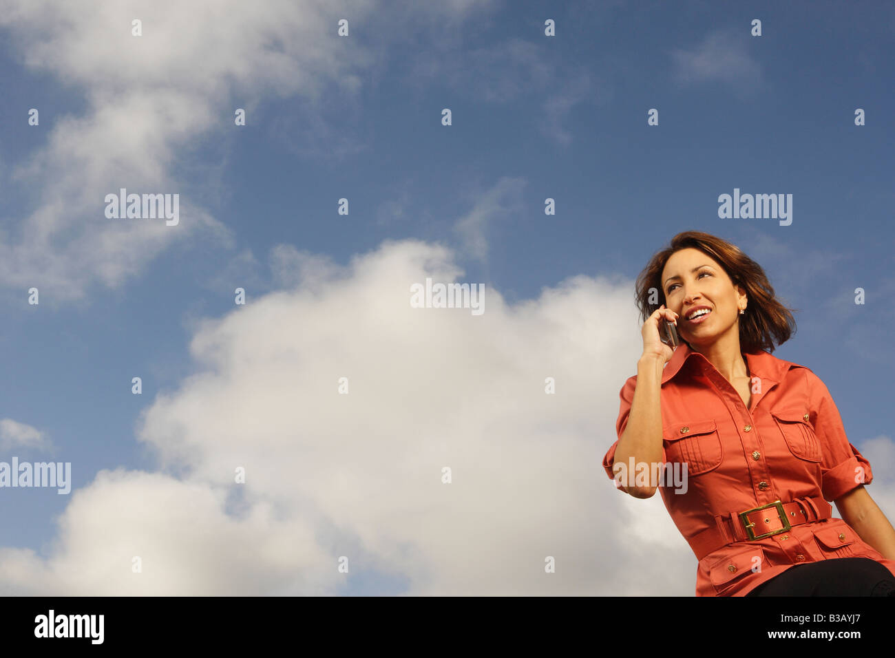 Hispanic woman talking on cell phone Stock Photo - Alamy