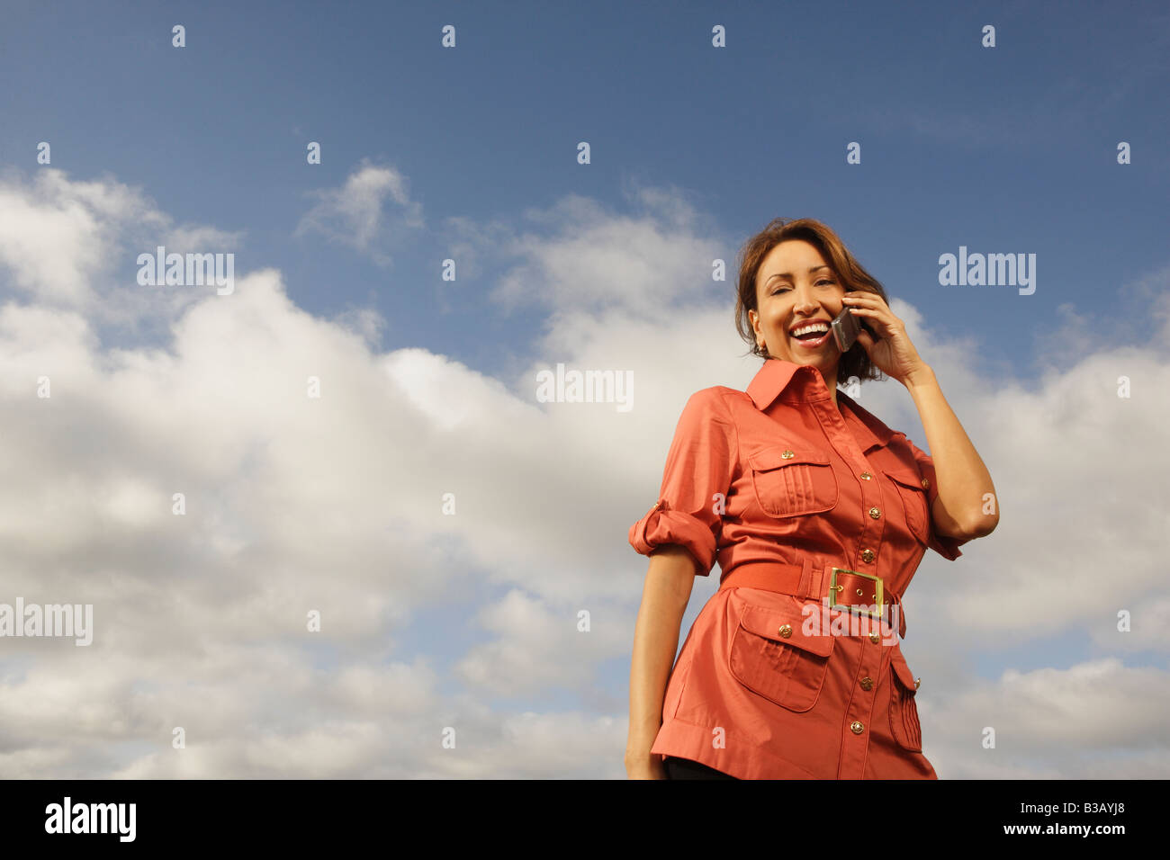 Hispanic woman talking on cell phone Stock Photo - Alamy