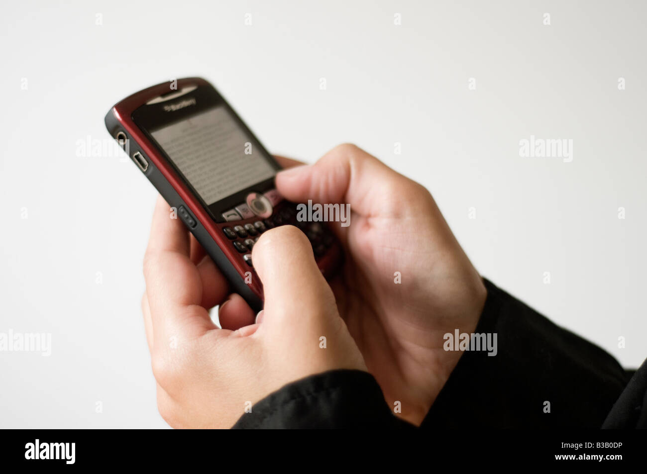 Close up of a woman working on Blackberry RIM Stock Photo