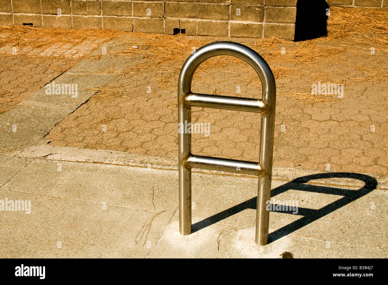 Rounded metal rack anchored to a sidewalk Stock Photo