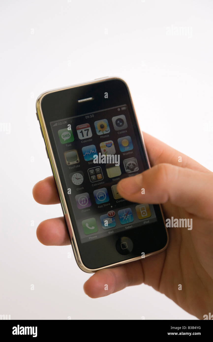 Man s hand holding Apple iphone mobile phone. England UK Britain Stock Photo