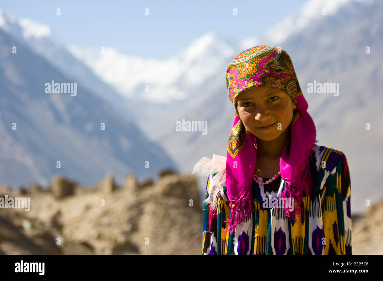 Young Tajik Girl in front of Yamchun or Zulkhomor Fort in the Wakhan Valley in Tajikistan Stock Photo