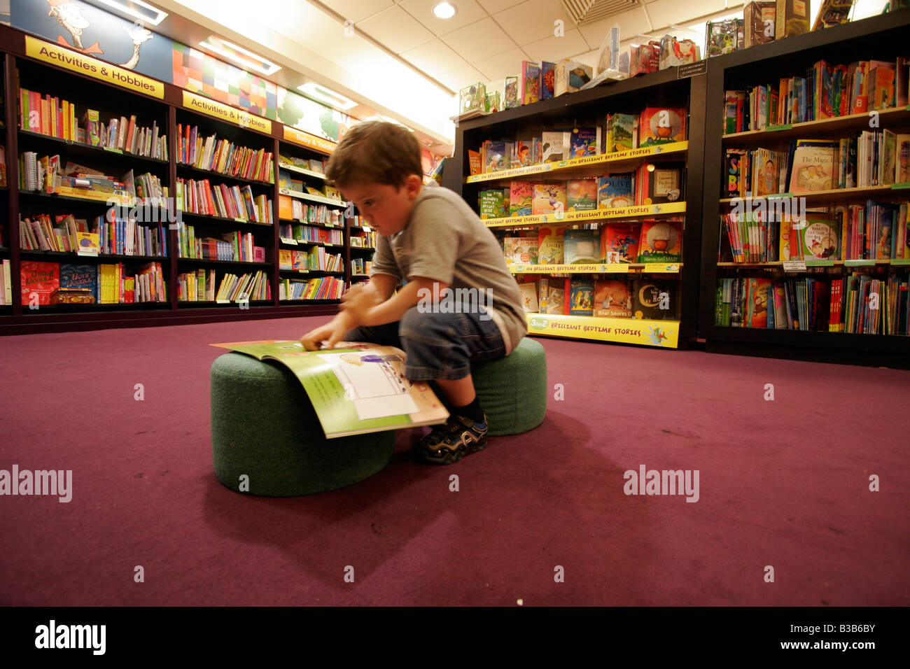 seven-year-old reading books at the Nottingham Waterstones store Stock Photo