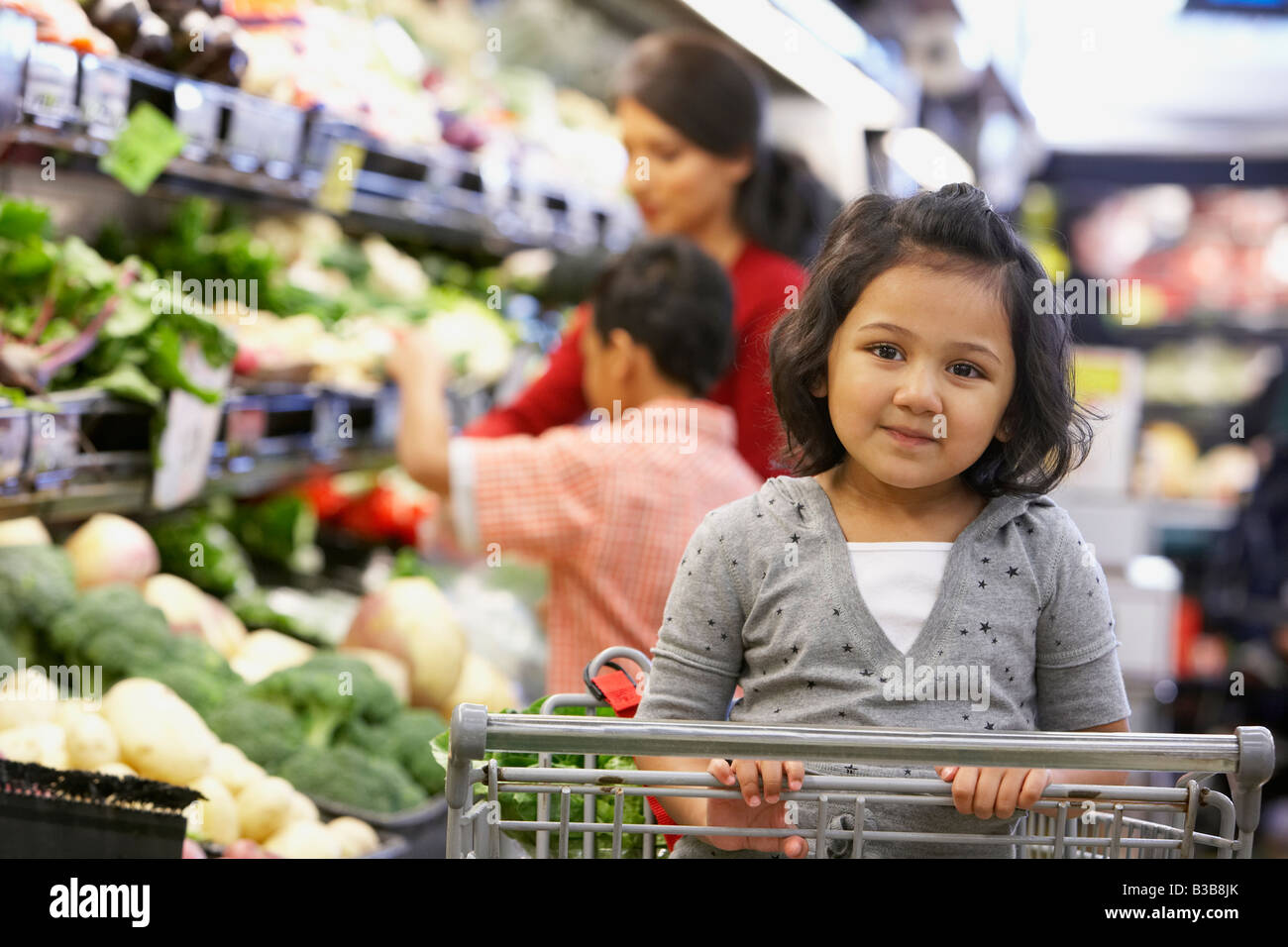 Indian girl sitting in shopping cart Stock Photo