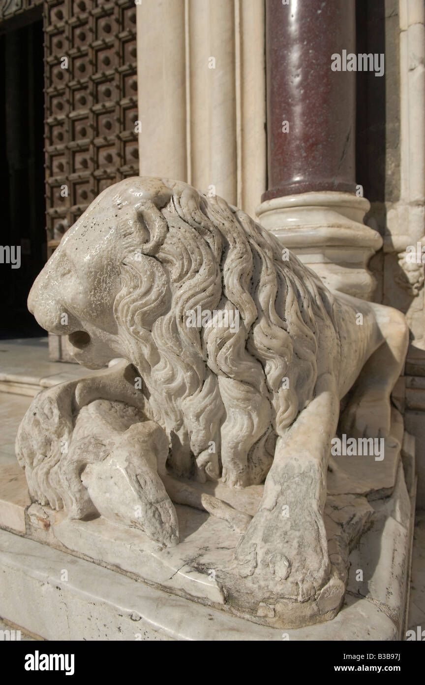14th Century lion outside middle portal of Duomo Stock Photo