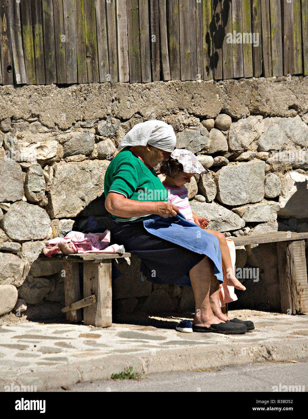 Girl sitting with grandmother in Bansko city Bulgaria Stock Photo
