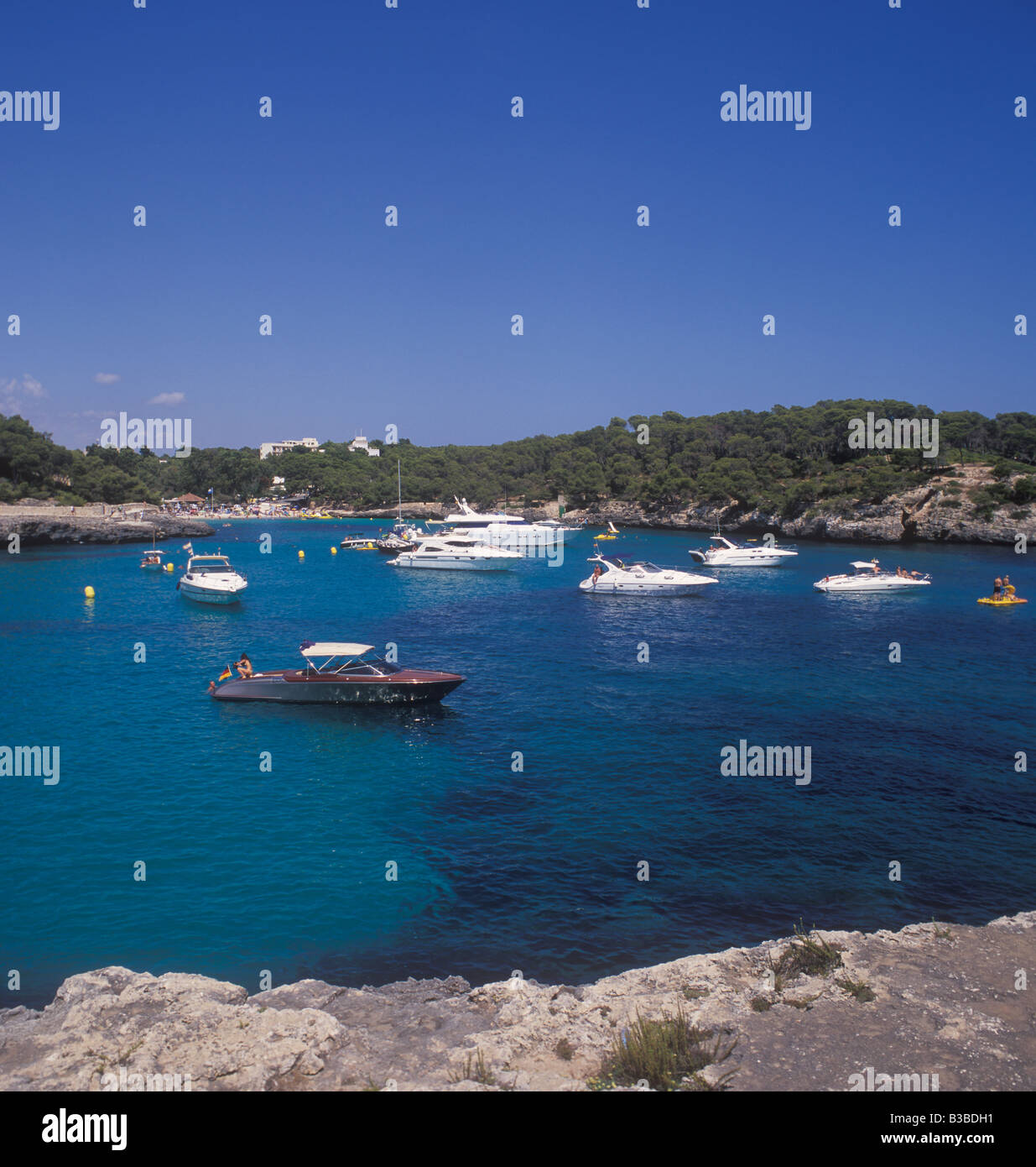 Scene in Cala Mondrago Natural Park - with motor boats and yachts at anchor  - near  Cala D'Or, East Coast Mallorca. Stock Photo