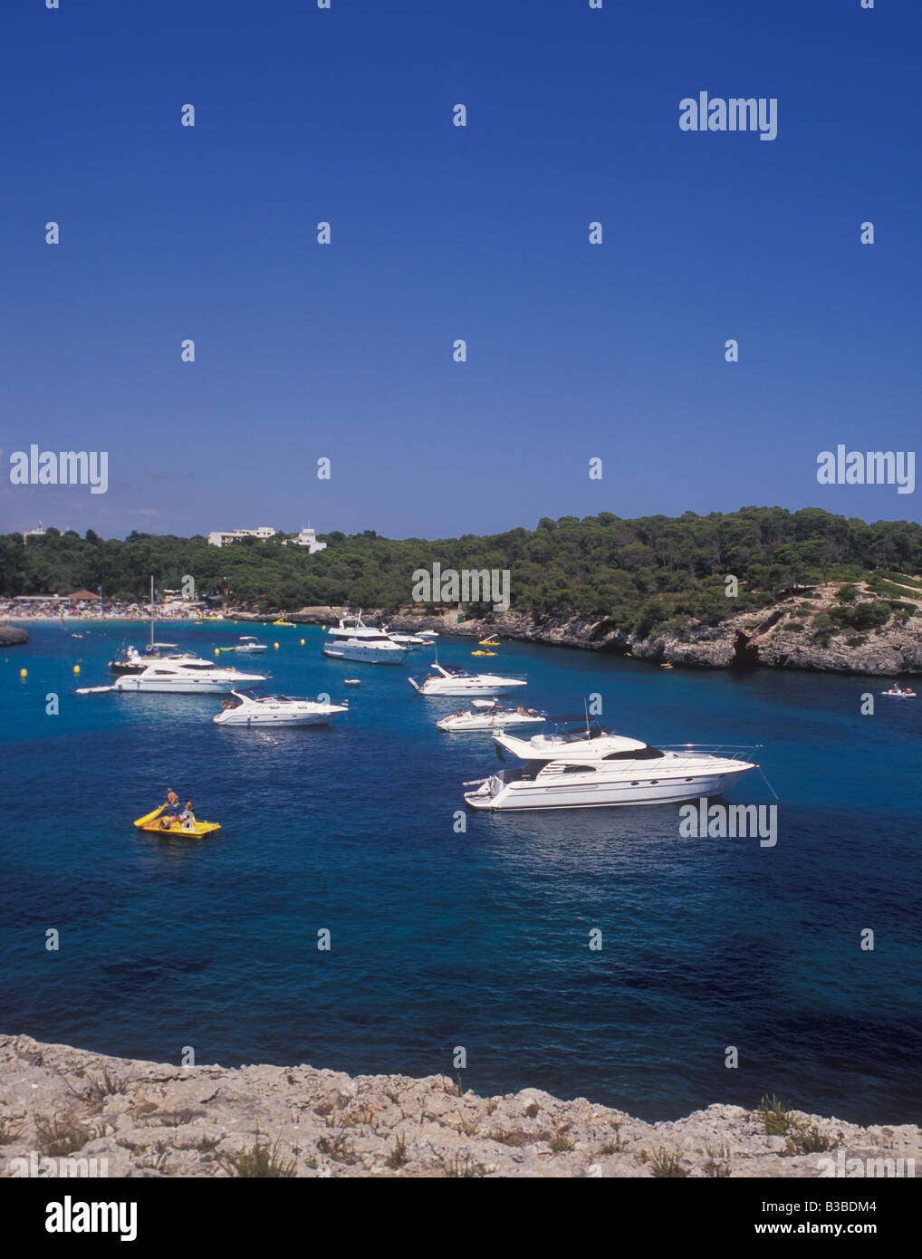 Scene in Cala Mondrago Natural Park - with motor boats and yachts at anchor  - near  Cala D'Or, East Coast Mallorca. Stock Photo