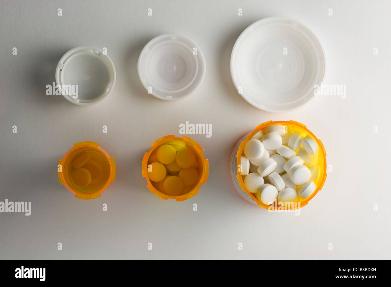 Bottles of tablets increasing in size Stock Photo