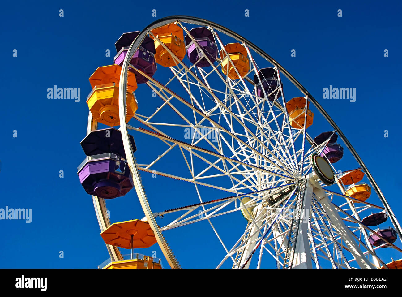 Pacific Park, Santa Monica CA pier family amusement park large Ferris wheel Roller Coaster moving over the ocean Stock Photo