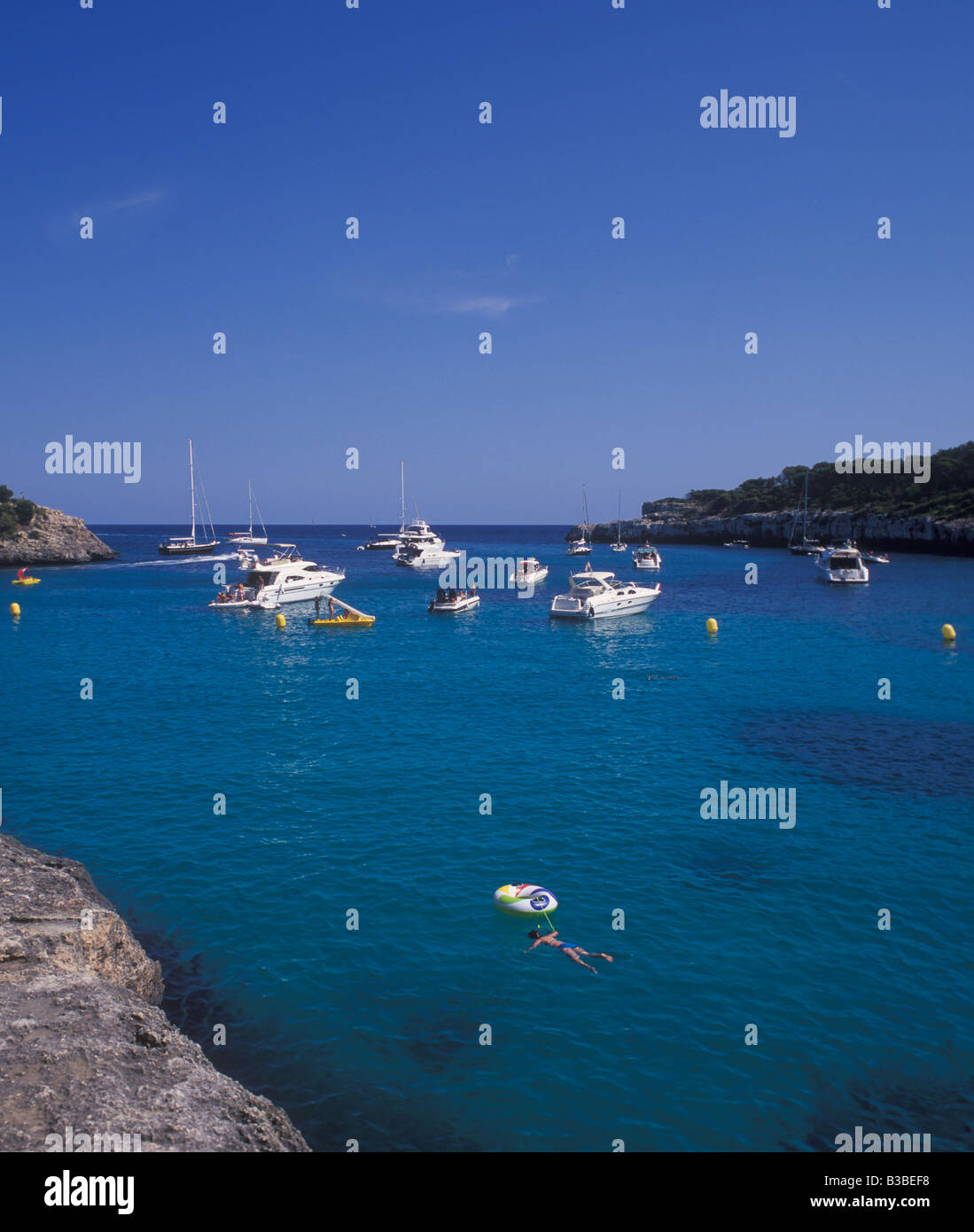 Scene in Cala Mondrago Natural Park - with motor boats and yachts at anchor  - near  Cala D'Or, East Coast Mallorca. Stock Photo