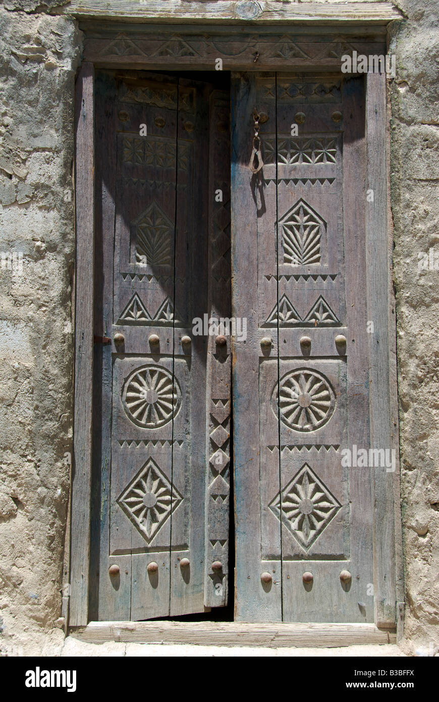 Wooden carved doors to house entrance Rustaq Al Batinah Region Sultanate of Oman Stock Photo