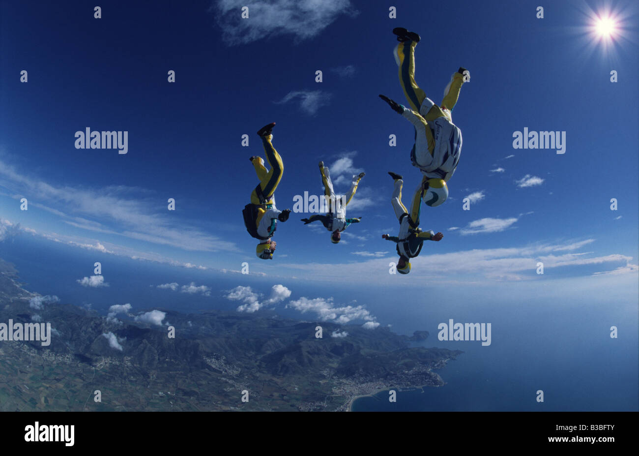 Four freeflyers zoom through the air above Empuriabrava in Spain Stock Photo