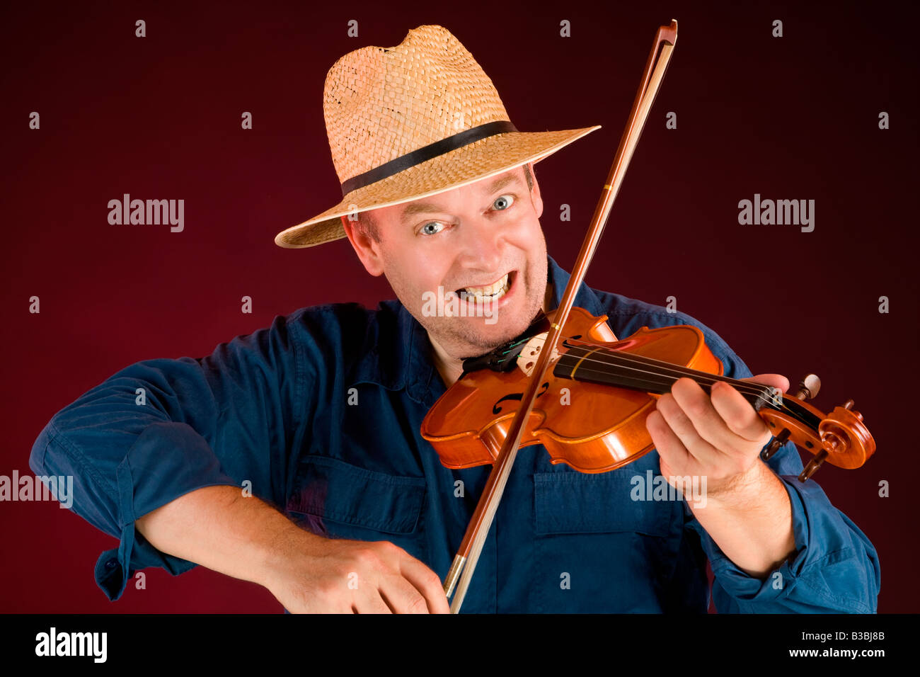 A man is playing country music on the fiddle Stock Photo