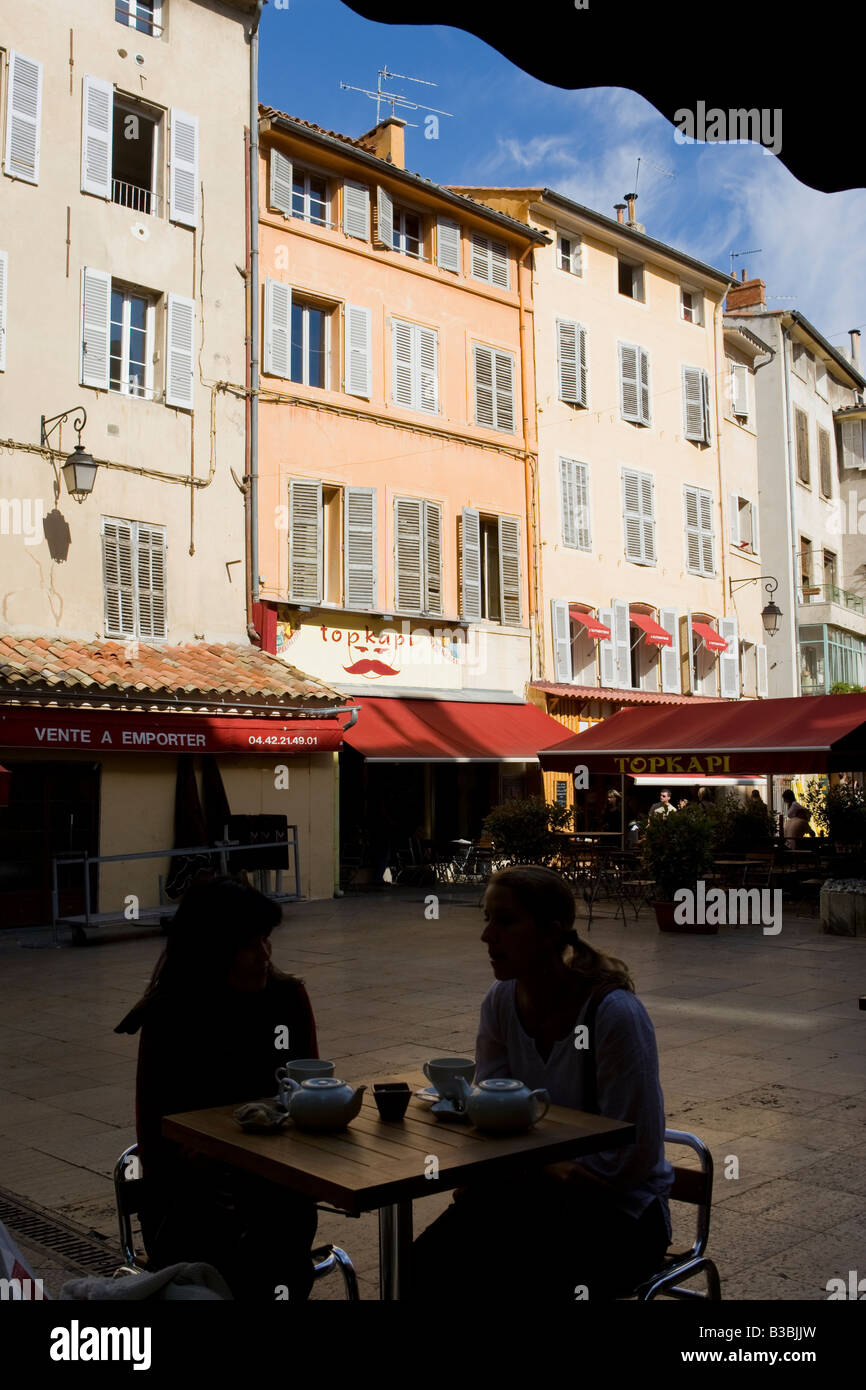 Old buildings and people in silhouette in a cafe in Aix en Provence ...