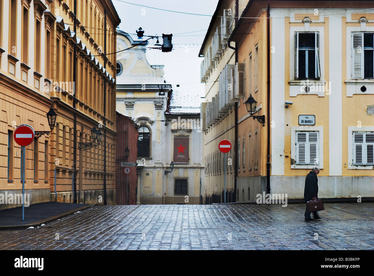 A man walks across Trg Sv Marka in Zagreb, Croatia Stock Photo