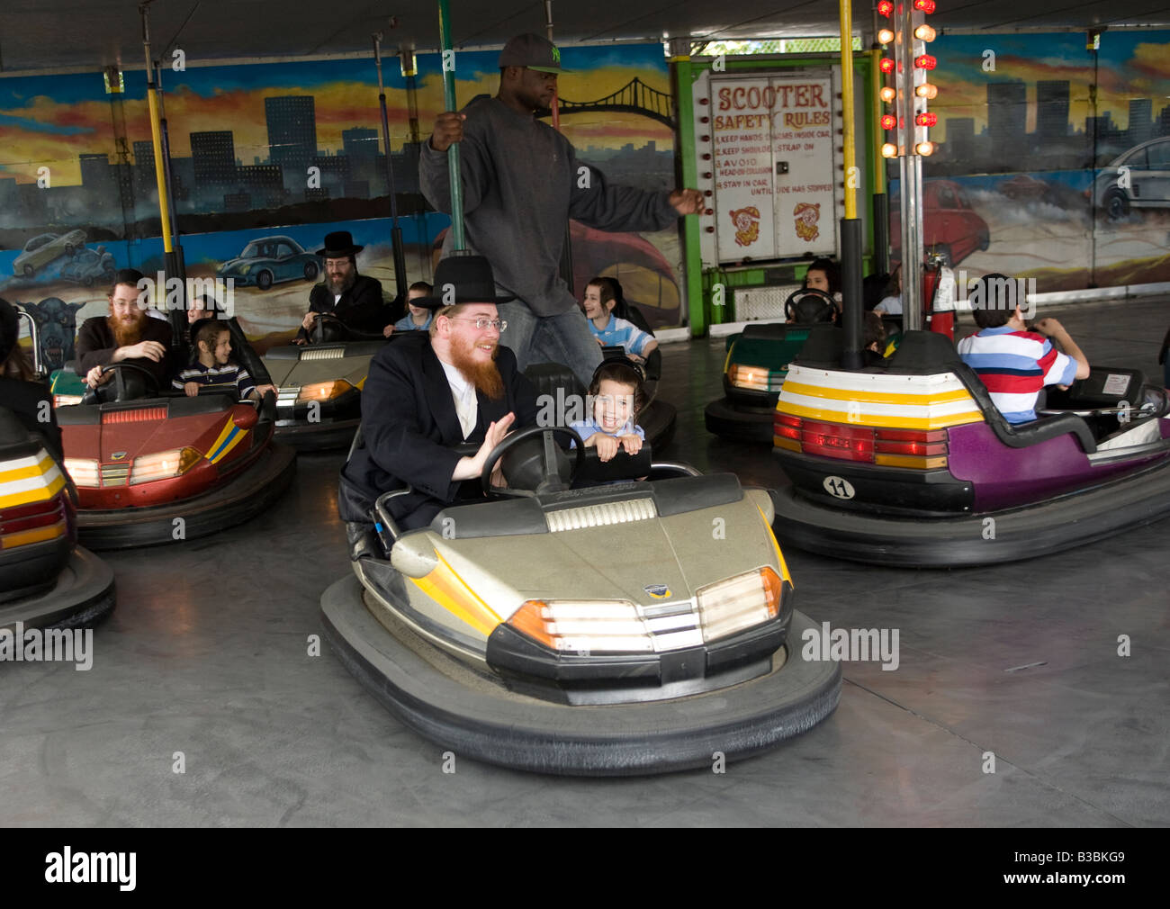 Orthodox Jewish men and boys ride the bumper cars at Coney Island Brooklyn New York Stock Photo