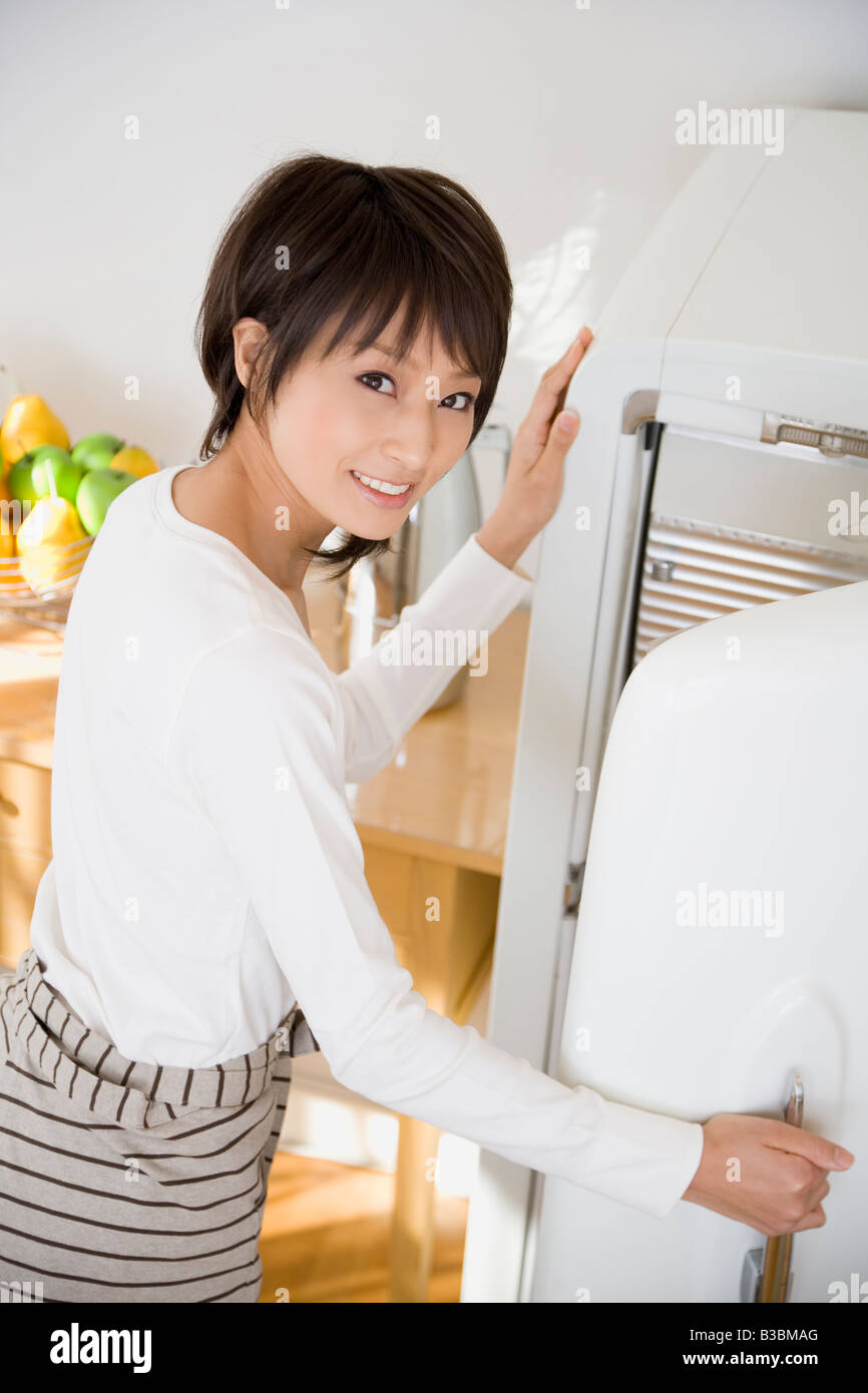Young woman opening refrigerator Stock Photo