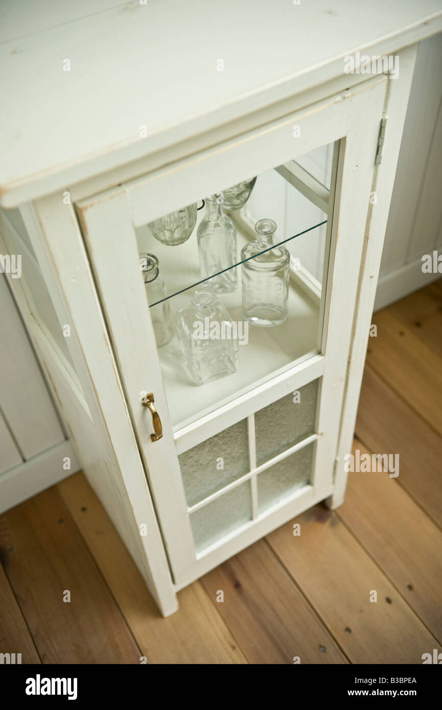 Empty bottles in cabinet Stock Photo