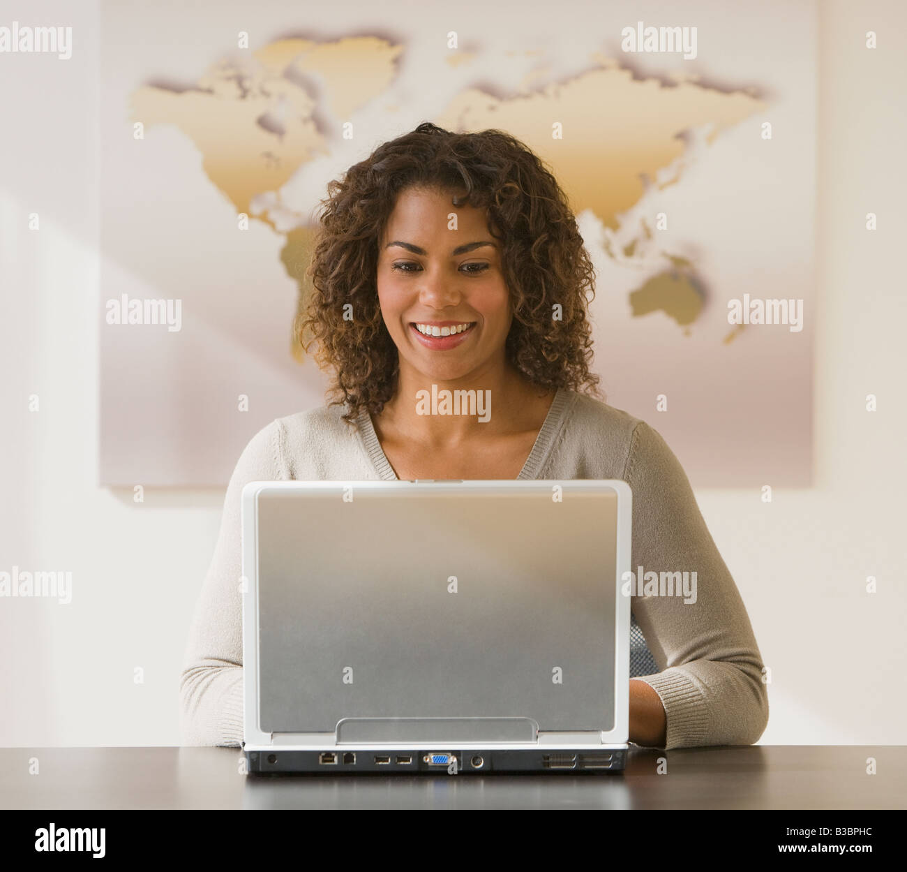 African businesswoman looking at laptop Stock Photo - Alamy