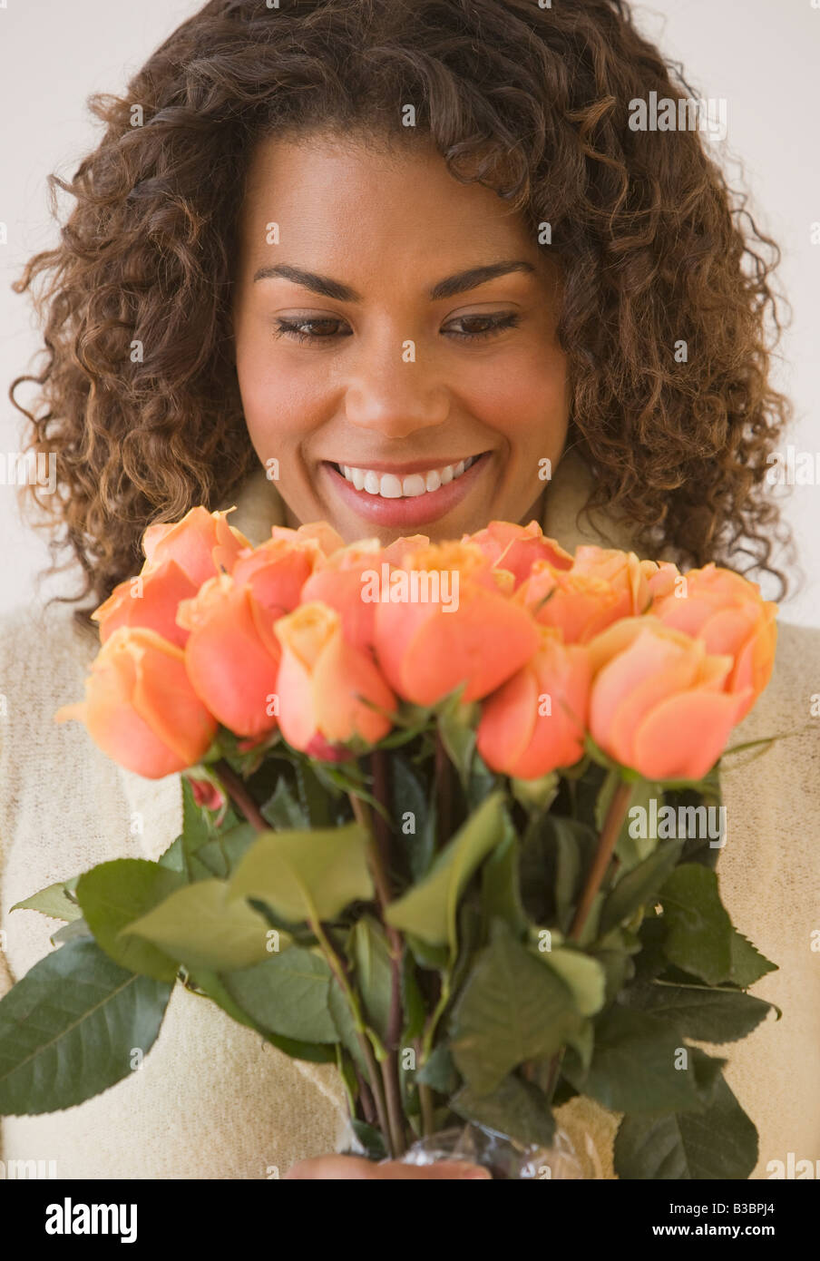 African woman holding bouquet of flowers Stock Photo - Alamy
