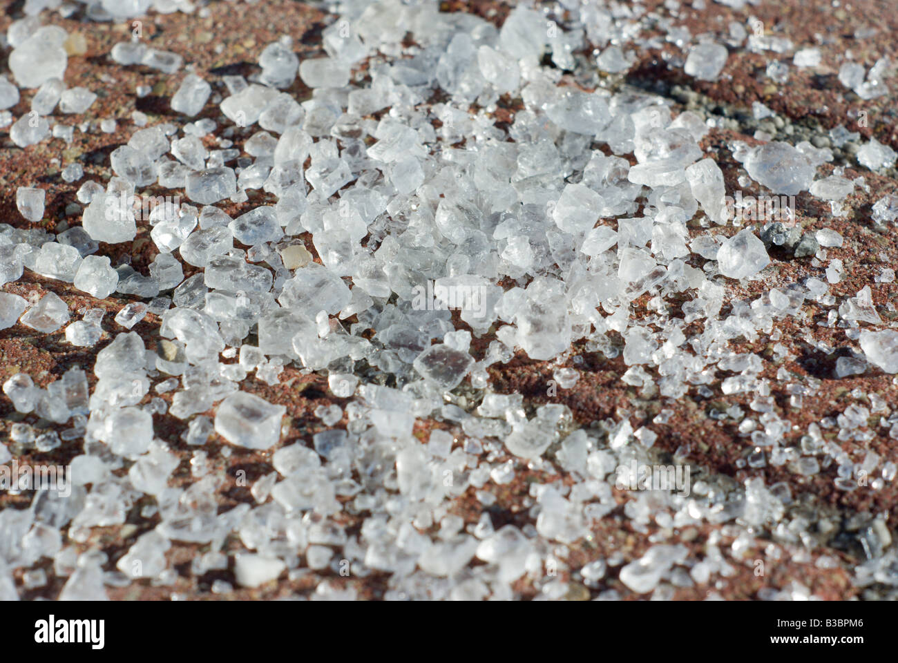 Rock salt lays atop red brick pavers on a sidewalk Stock Photo Alamy