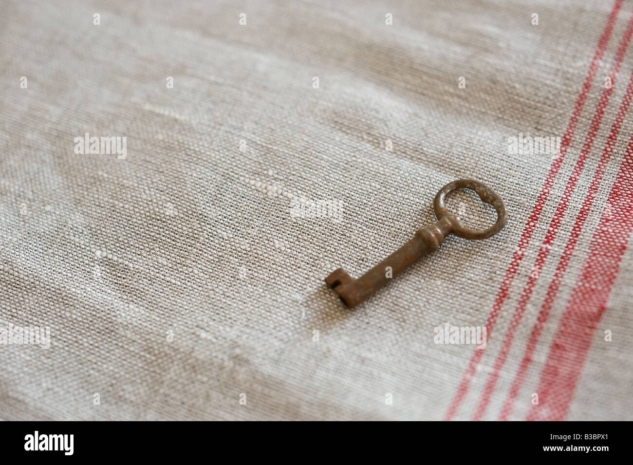 Old key on fabric Stock Photo
