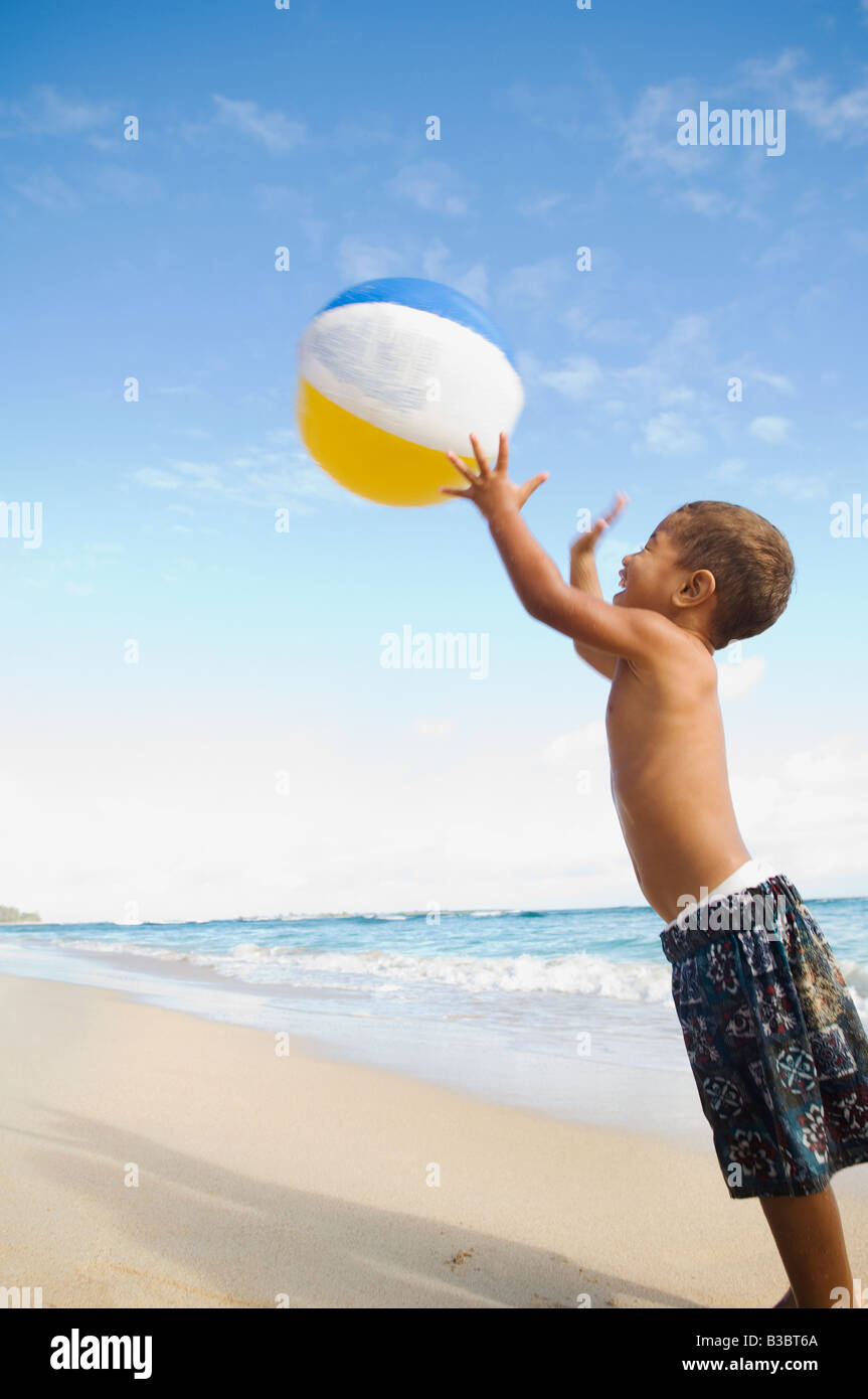 Pacific Islander boy playing with beach ball Stock Photo