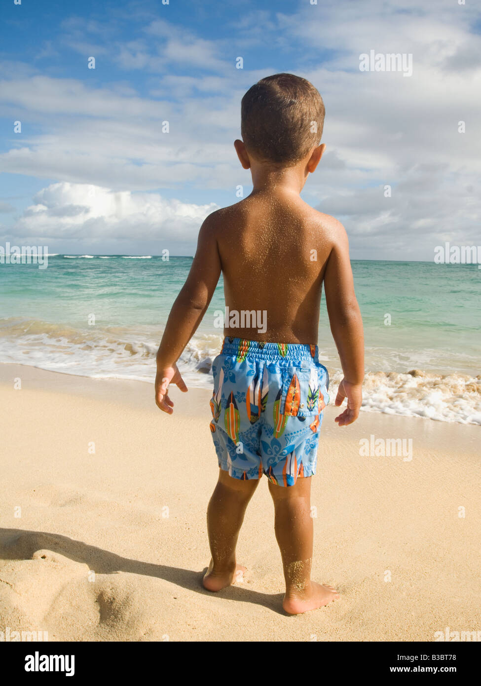 Pacific Islander boy looking at ocean Stock Photo