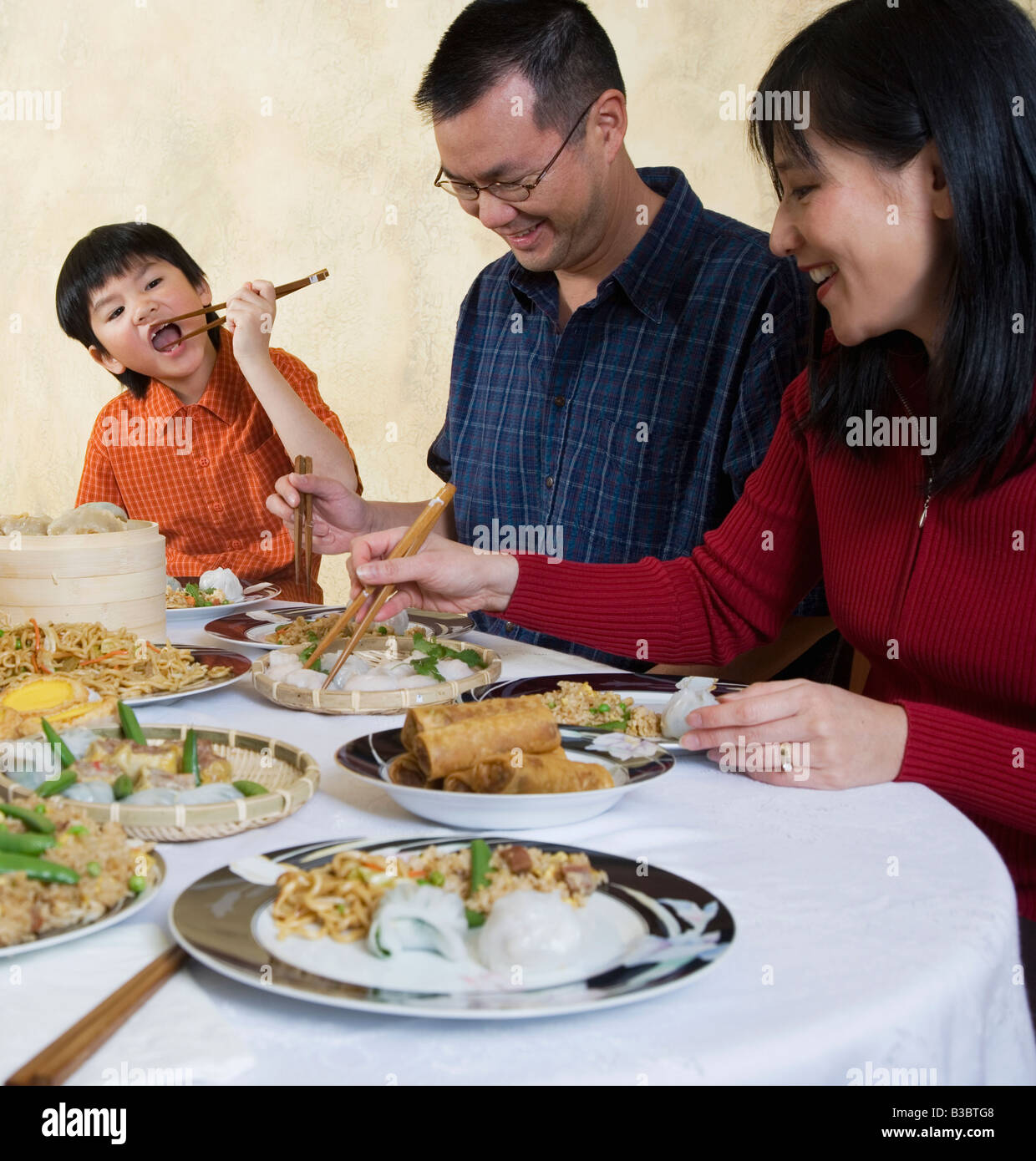 Asian family eating at dinner table Stock Photo - Alamy