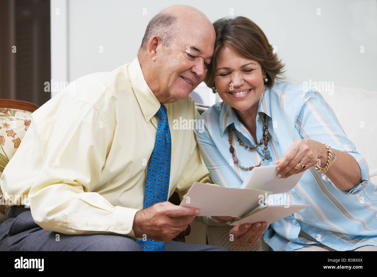 Senior Hispanic couple looking at photographs Stock Photo - Alamy