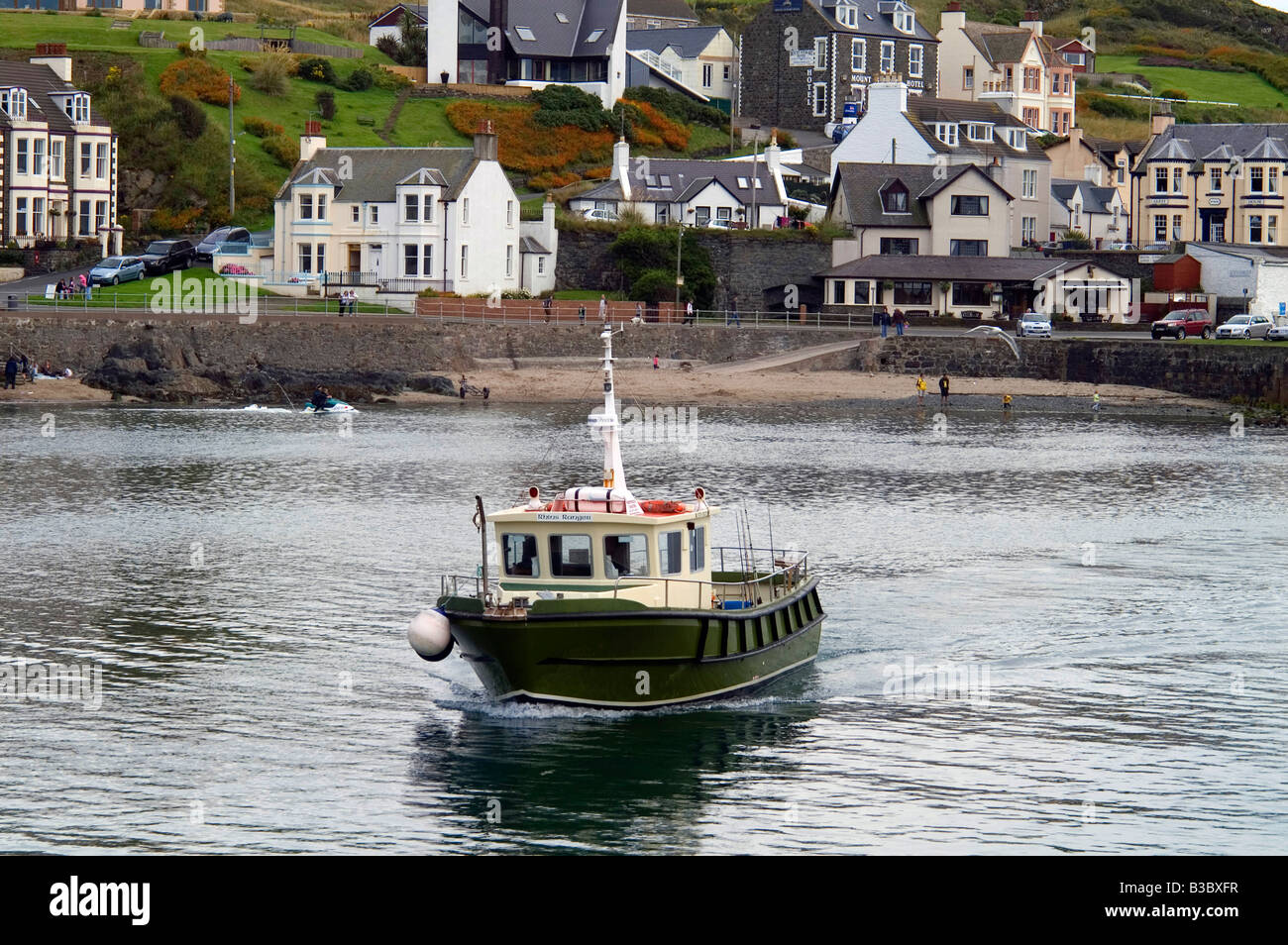Boat sailing into Portpatrick Harbour, Dumfries and Galloway, Scotland Stock Photo