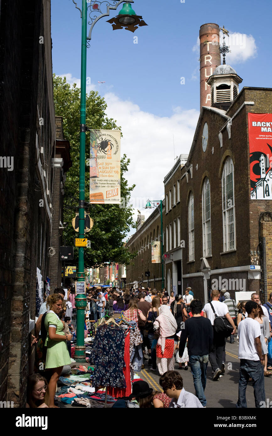 Truman brewery, chimney and crowd in Brick Lane Market. Shoreditch, Tower Hamlets, London, England Stock Photo