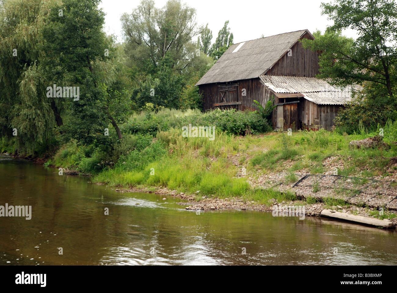 Old wooden barn standing close to Liwiec river bank, Masovia region in Poland Stock Photo