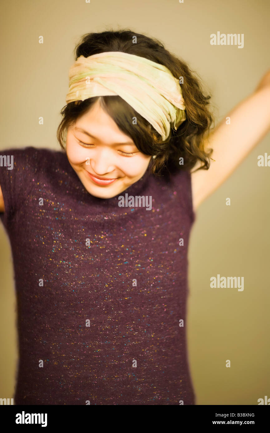 Asian woman smiling with eyes closed Stock Photo - Alamy