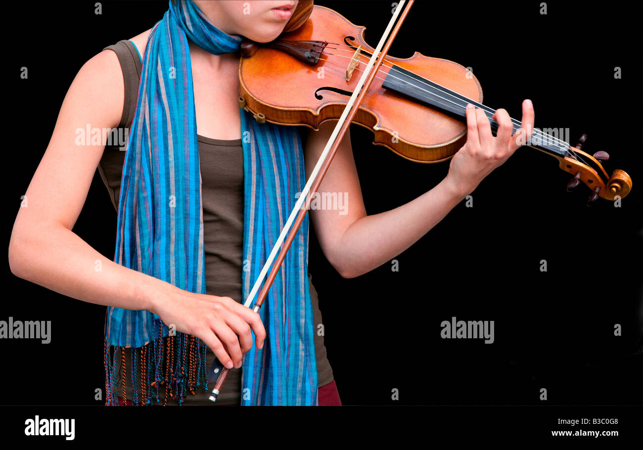 A girl is playing the violin on a black background Stock Photo - Alamy
