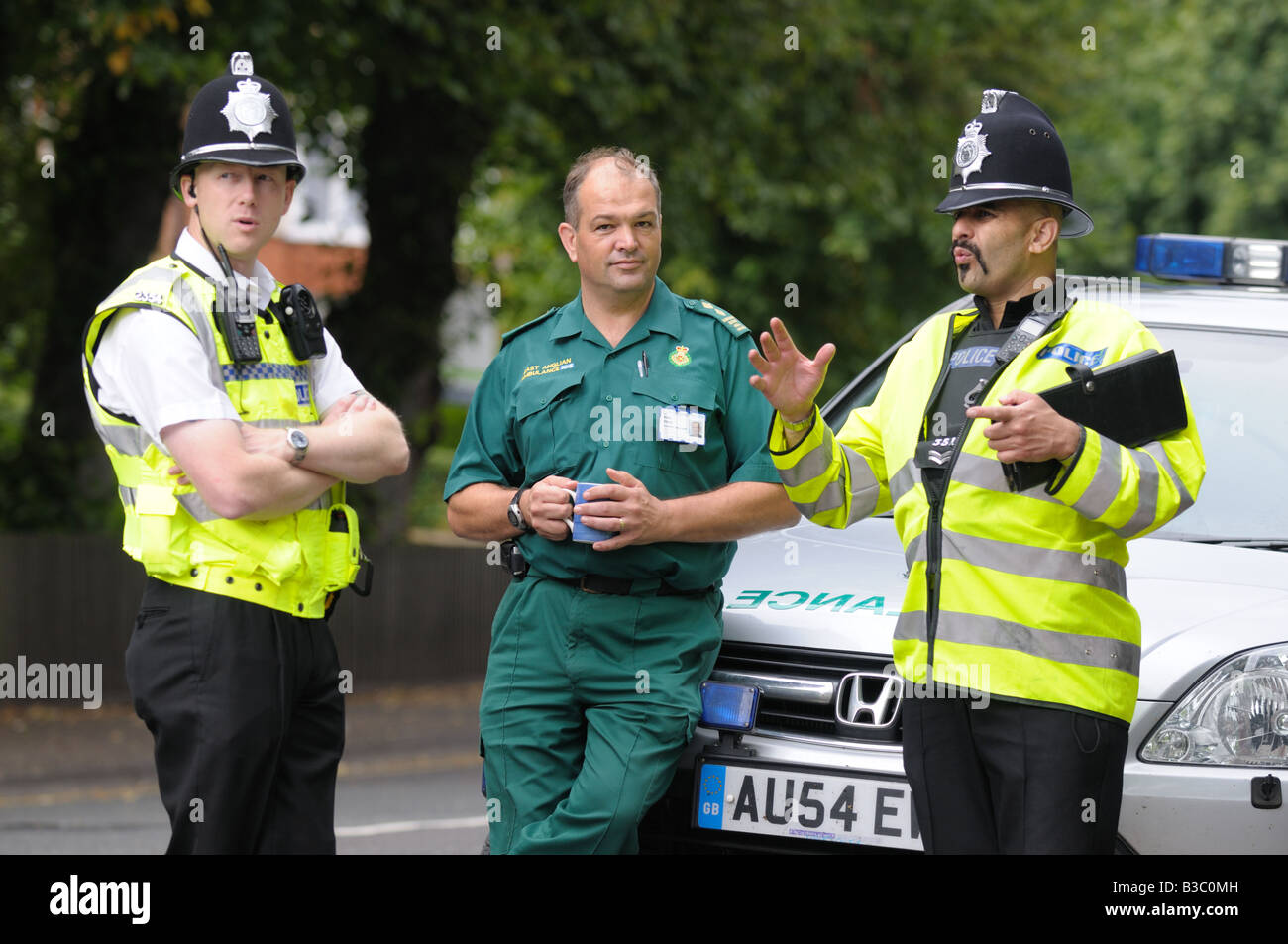 Police and Paramedic wait at the scene of an emergency Stock Photo