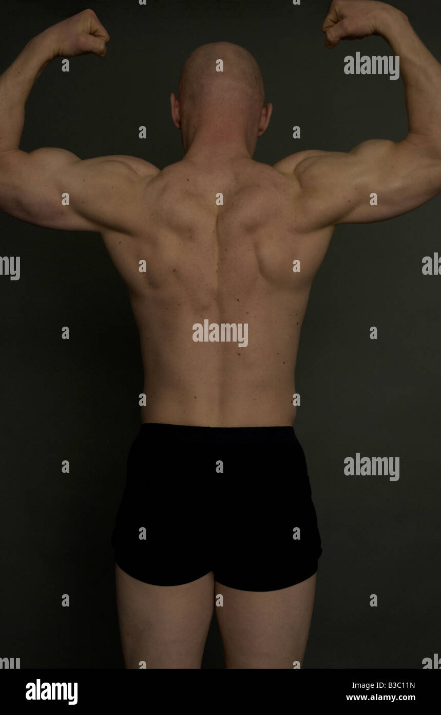 The back of man tensing his muscles Stock Photo Alamy